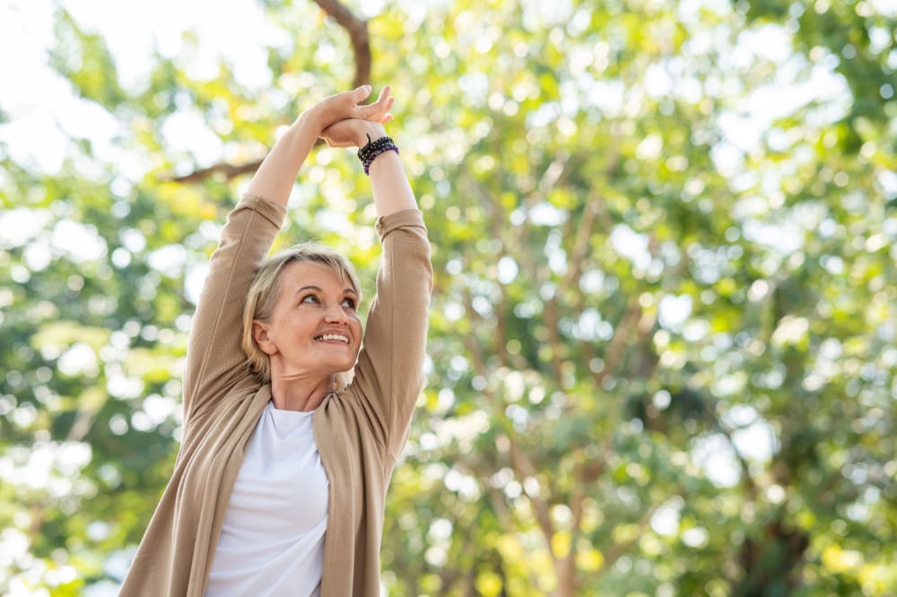 Senior woman enjoying fresh outdoor spring air, staying active and healthy